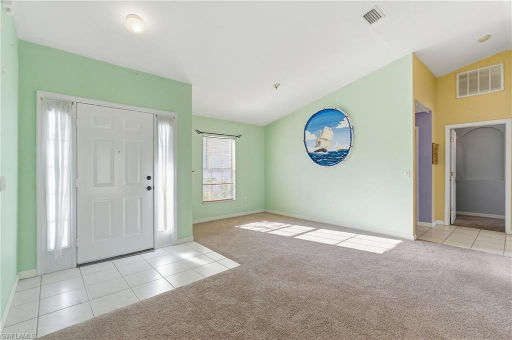 1562 Jakway Road North Port, FL 34288 - Photo 8 of 50 Entryway featuring light tile patterned floors, lofted ceiling, and light carpet