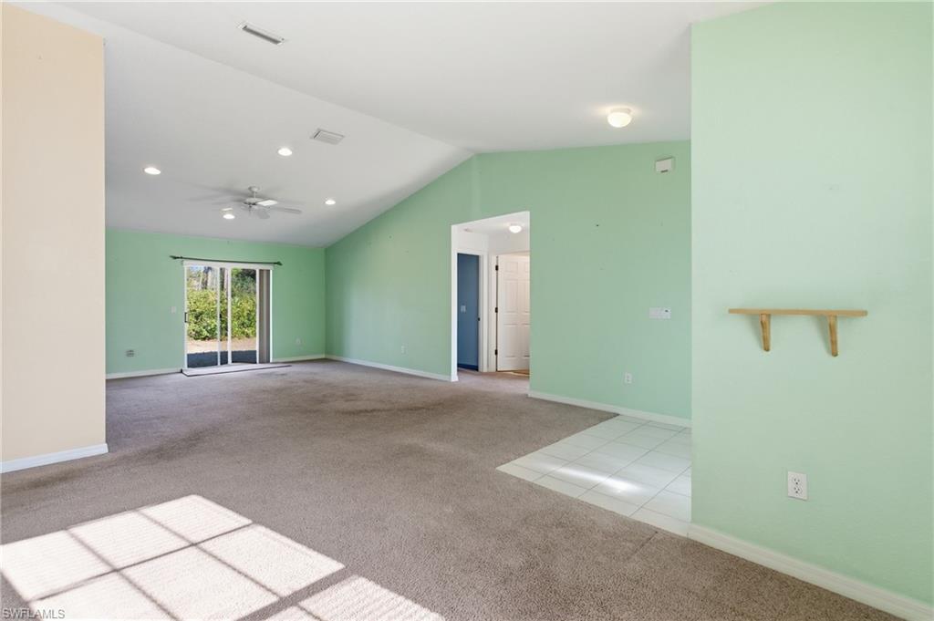 1562 Jakway Road North Port, FL 34288 - Photo 10 of 50 Empty room featuring light carpet, ceiling fan, and light tile patterned floors
