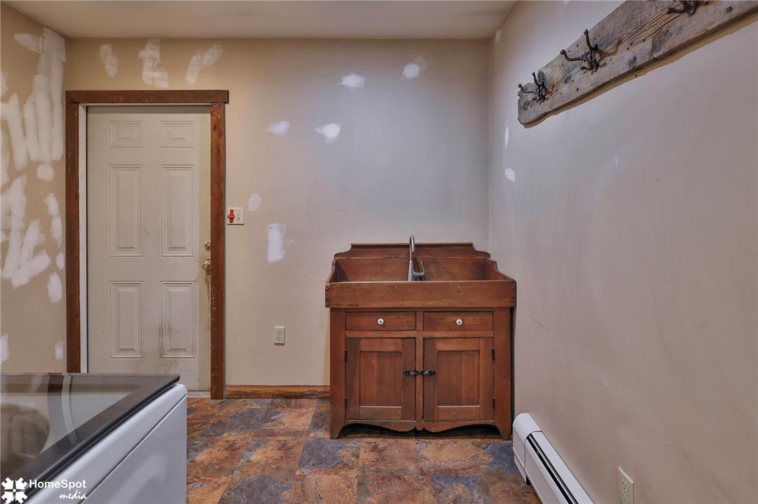 829 Georgetown Road Nazareth, PA 18064 - Photo 24 of 54 Functional service area features a rustic wooden vanity sink and durable stone-look flooring.