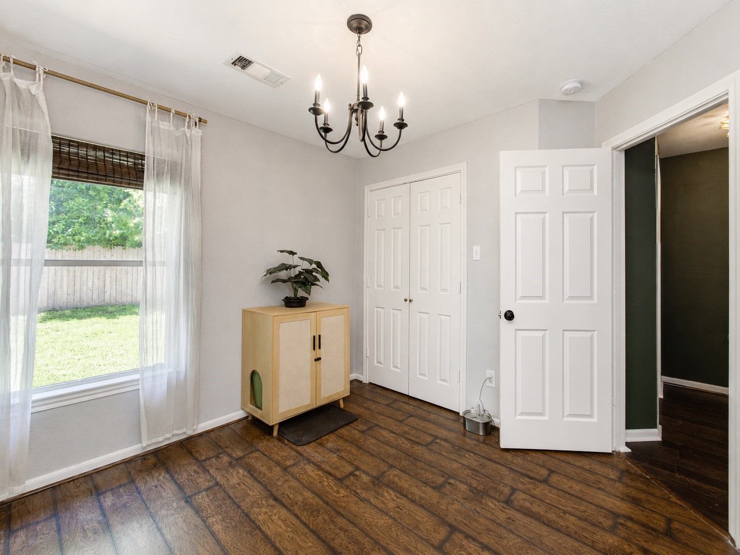 8647 Suburban Oaks Road Houston, TX 77093 - Photo 16 of 21 This secondary bedroom angle shows the chandelier detail, closet access, and clean floor space. (photo has been enhanced for marketing purposes)