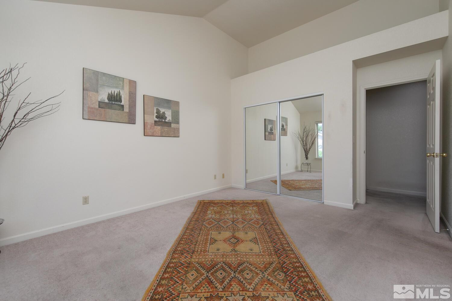 3335 Spring Creek Circle Reno, NV 89509 - Photo 11 of 30 a view of a hallway with wooden floor and a bathroom