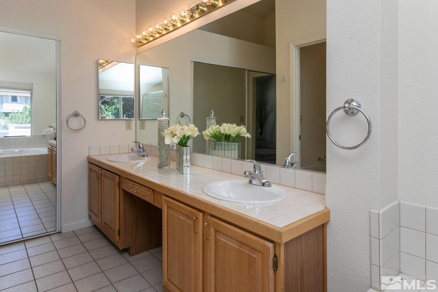 3335 Spring Creek Circle Reno, NV 89509 - Photo 14 of 30 a bathroom with a sink and a mirror