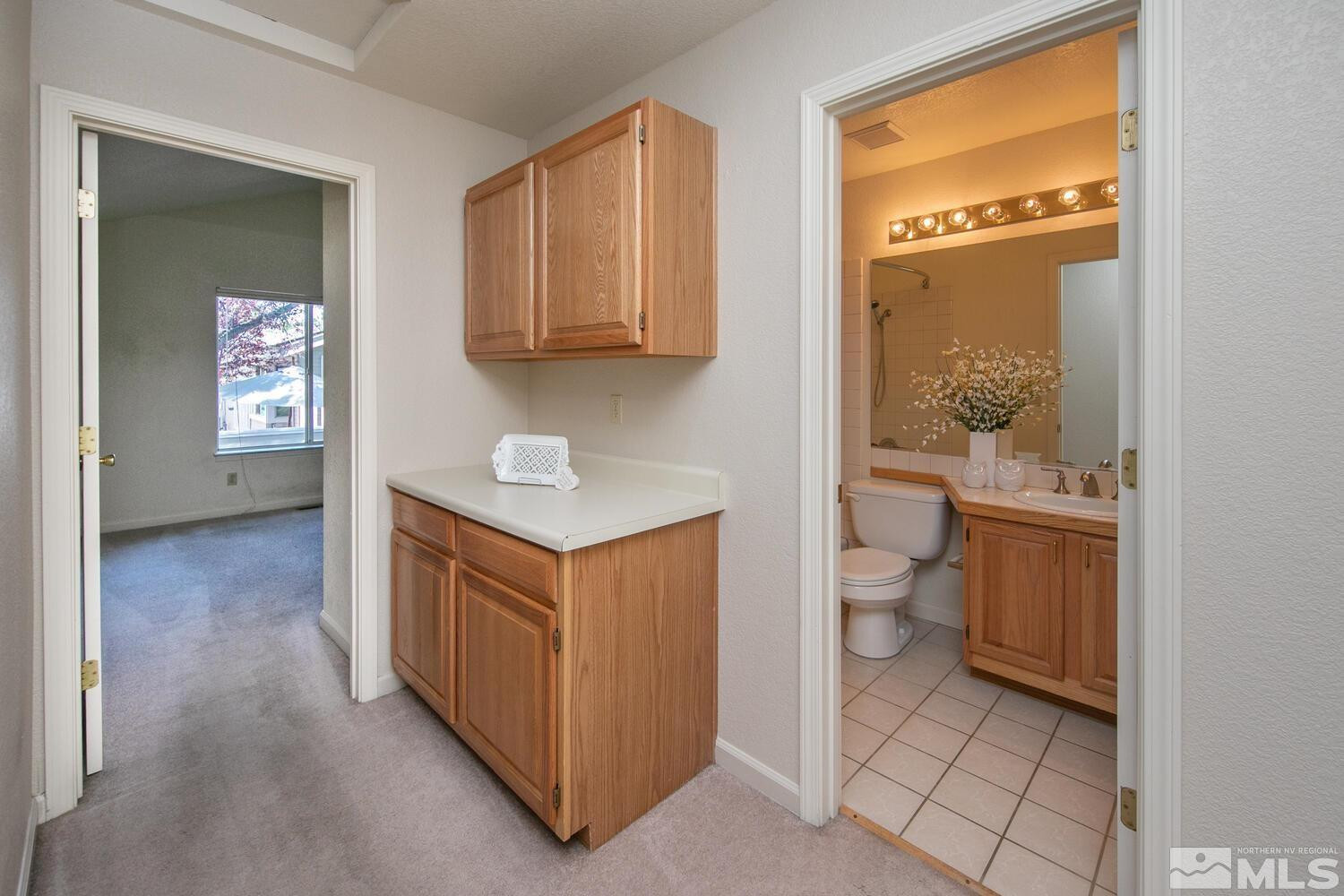 3335 Spring Creek Circle Reno, NV 89509 - Photo 17 of 30 a view of bathroom with a toilet sink and a mirror