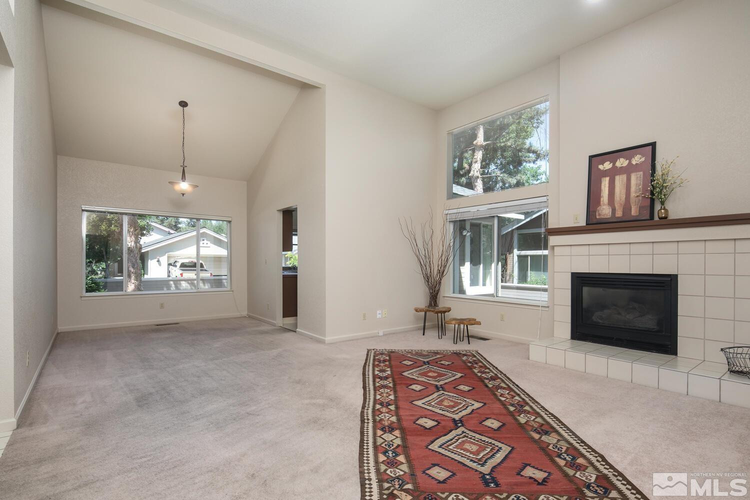 3335 Spring Creek Circle Reno, NV 89509 - Photo 2 of 30 a living room with furniture a window and a fireplace