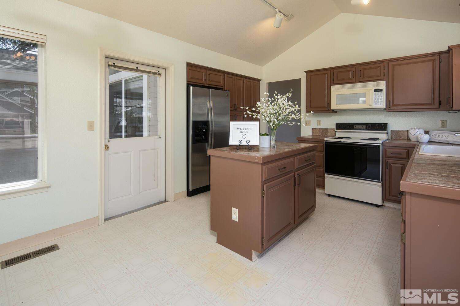 3335 Spring Creek Circle Reno, NV 89509 - Photo 8 of 30 a kitchen with stainless steel appliances a stove a refrigerator sink and cabinets