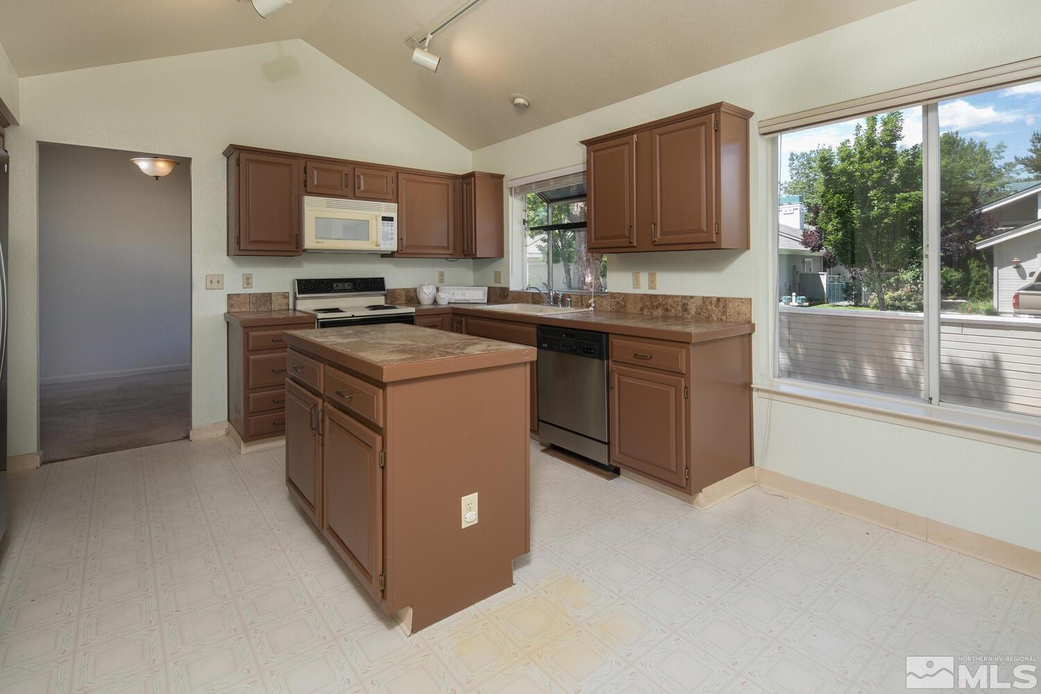 3335 Spring Creek Circle Reno, NV 89509 - Photo 9 of 30 a kitchen with stainless steel appliances granite countertop a stove top oven