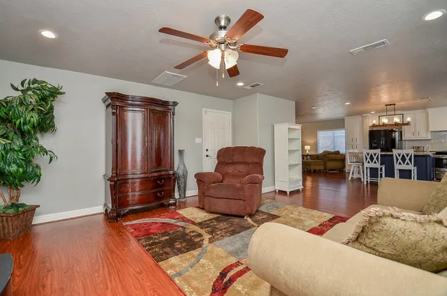 a kitchen with granite countertop kitchen island stainless steel appliances a stove sink and cabinets