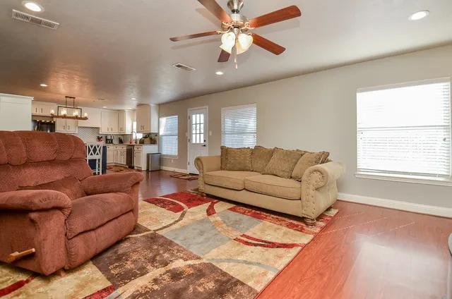 a living room with furniture and kitchen view