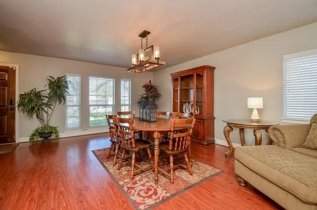 a view of a dining room with furniture and wooden floor