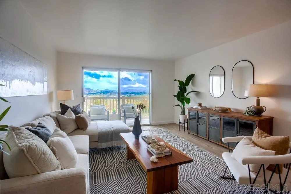 a living room with furniture a window and a table