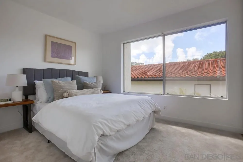 1870 Forestdale Drive Encinitas, CA 92024 - Photo 14 of 19 a bedroom with a bed and glass window