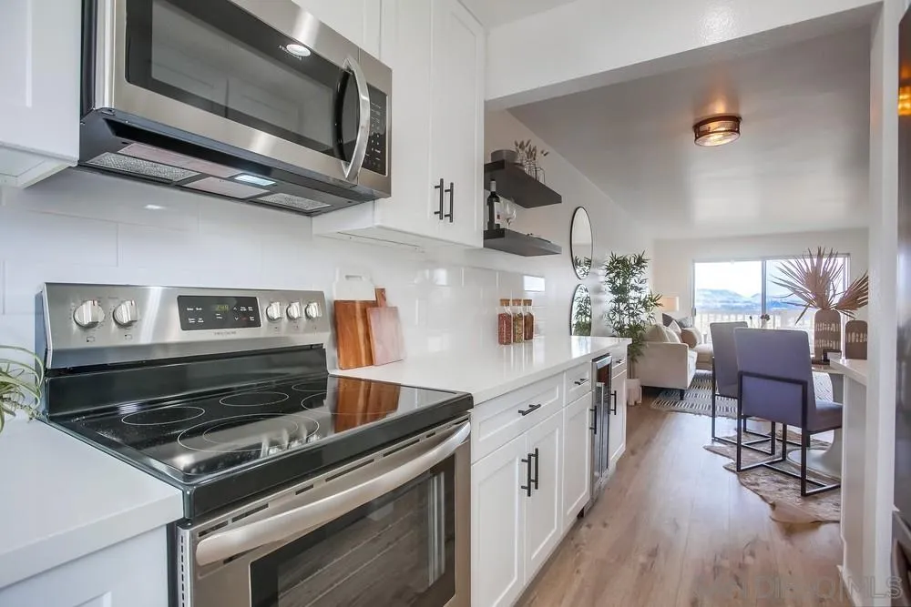 1870 Forestdale Drive Encinitas, CA 92024 - Photo 7 of 19 a kitchen with stainless steel appliances granite countertop a stove and a microwave