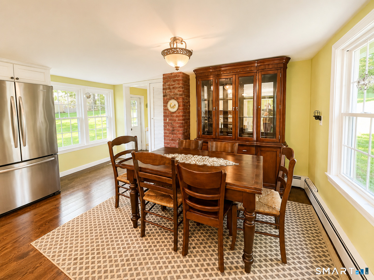 443 Amity Road Bethany, CT 06524 - Photo 11 of 30 a dining room with furniture a chandelier and wooden floor