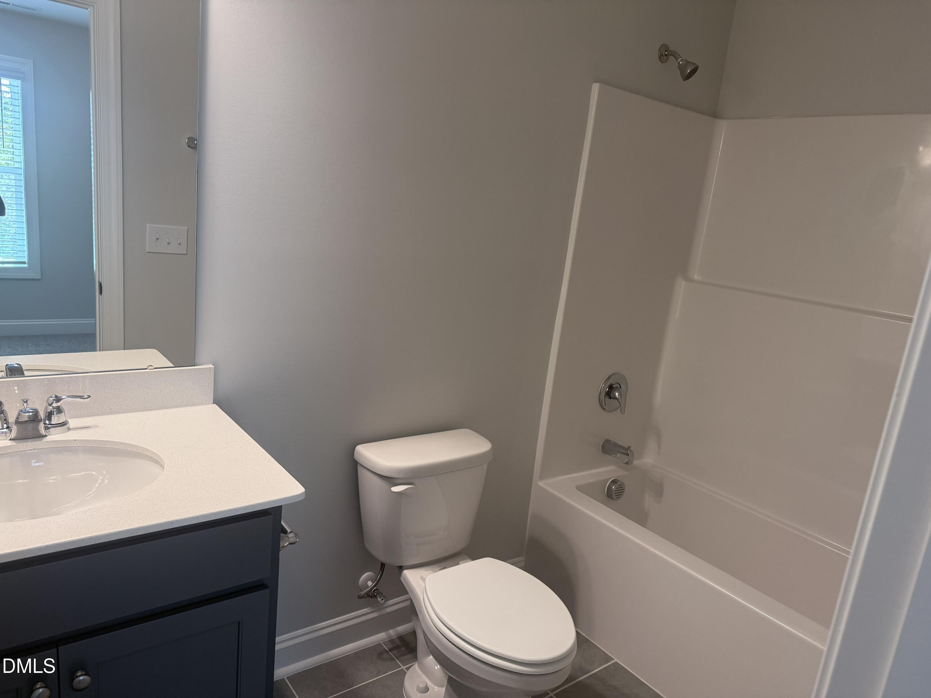 1920 Fishamble Street Fuquay-Varina, NC 27526 - Photo 18 of 23 a white toilet sitting next to a bathroom sink