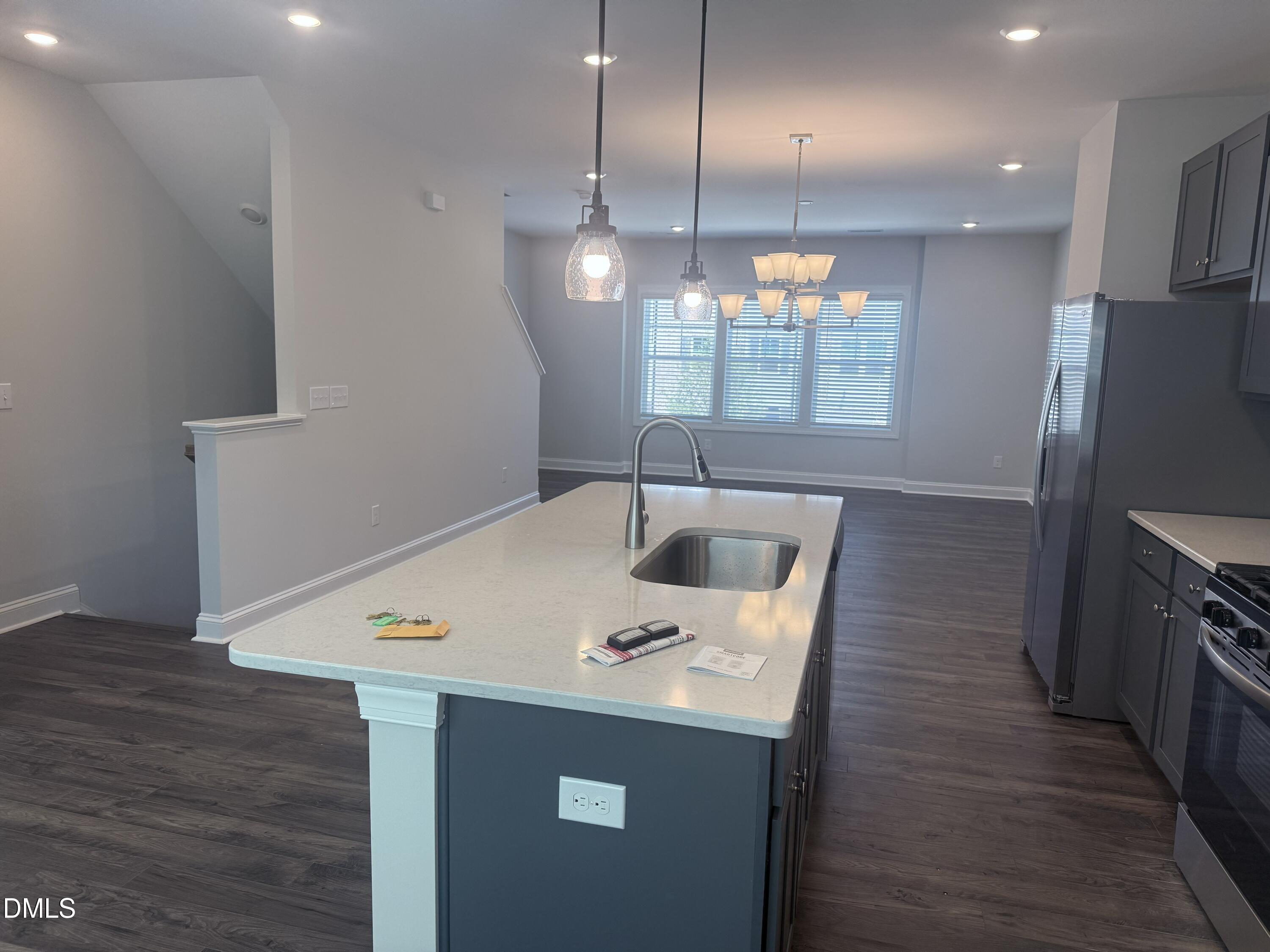 1920 Fishamble Street Fuquay-Varina, NC 27526 - Photo 6 of 23 a kitchen with kitchen island a sink appliances and wooden floor
