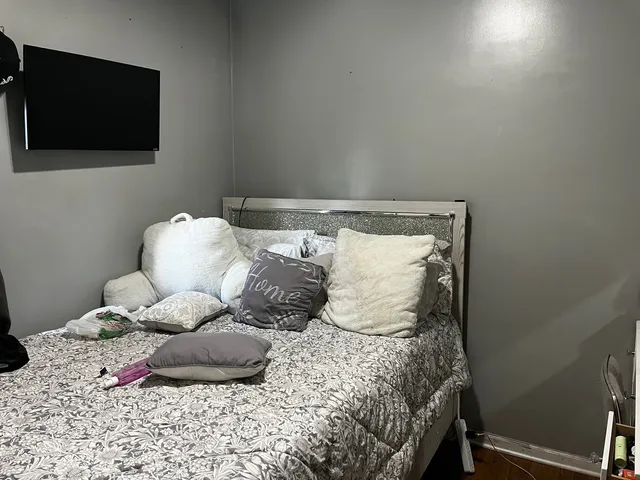 a bedroom with a bed and a flat screen tv