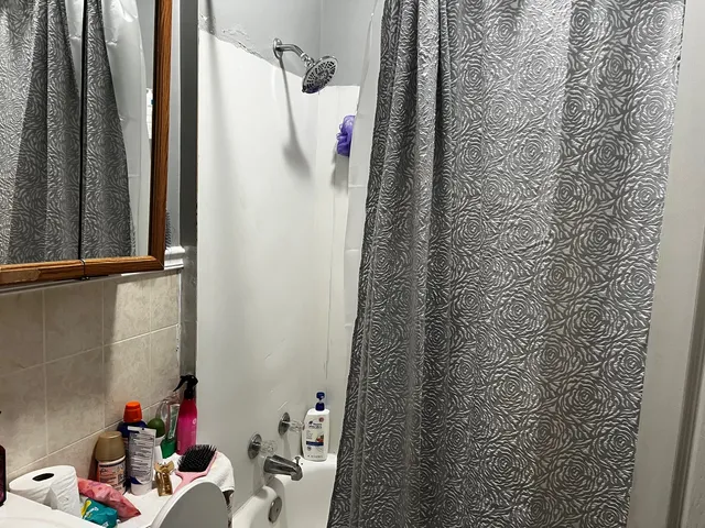 a bathroom with a sink and a shower curtain