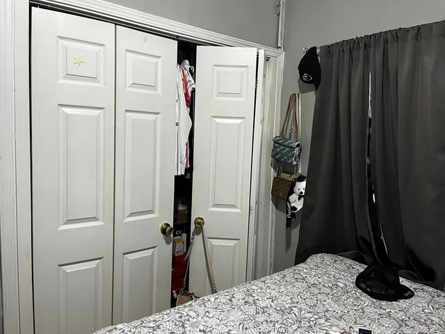 a bedroom with a bed and a mirror