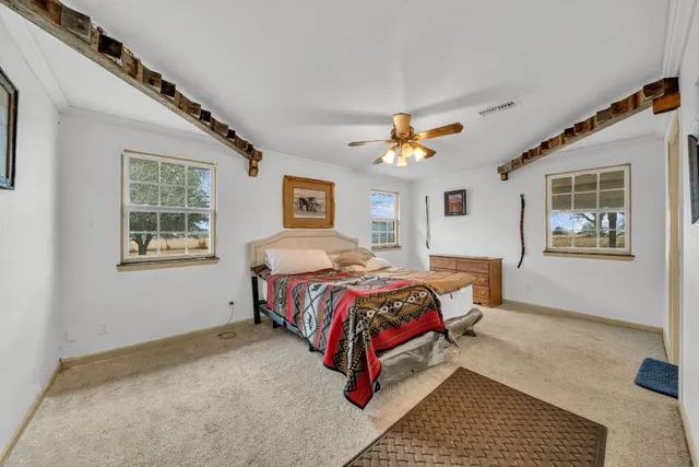 a bedroom with a bed lamp and a window