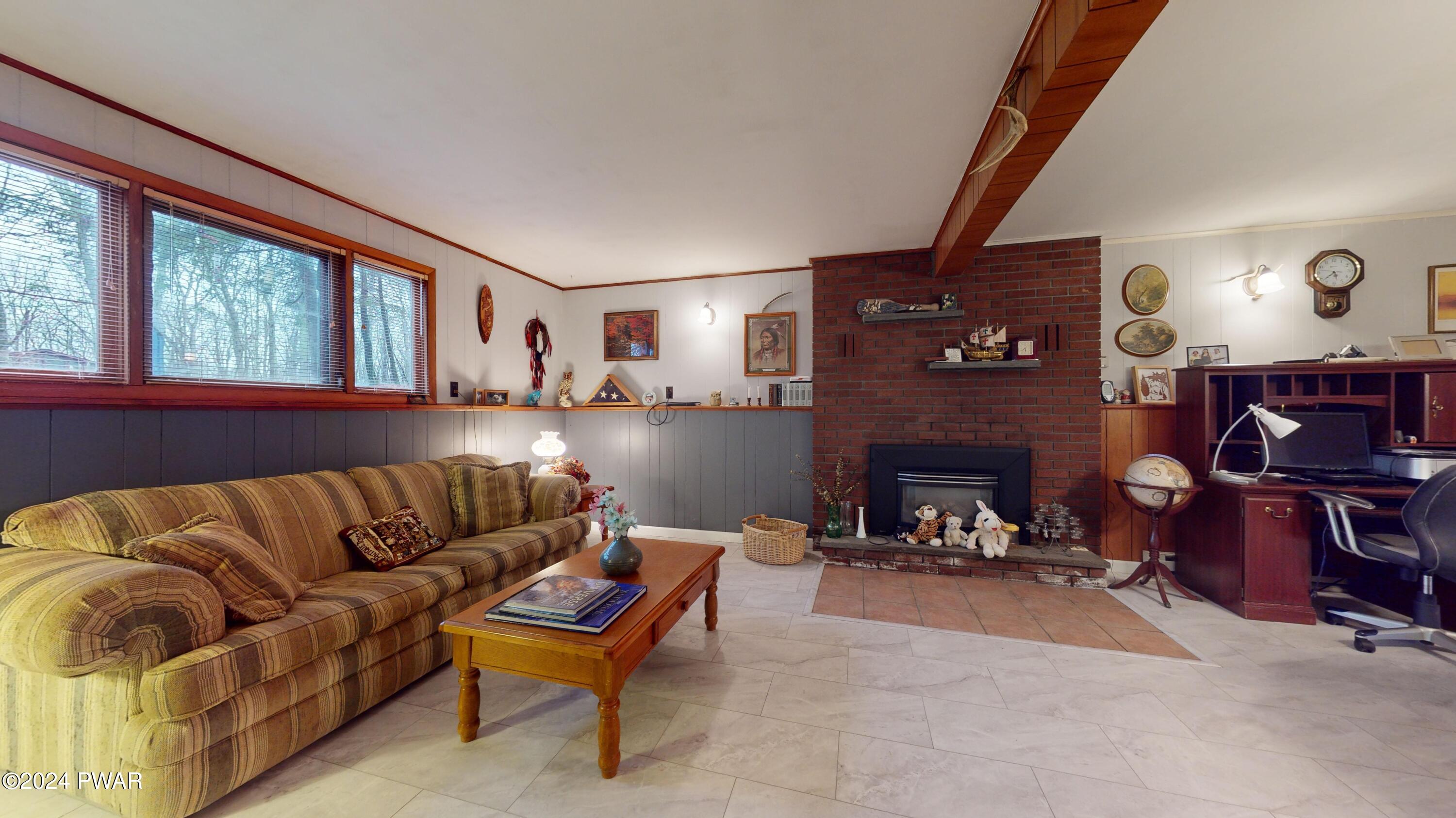 134 Sunnylands Road Milford, PA 18337 - Photo 8 of 59 a living room with furniture and a fireplace