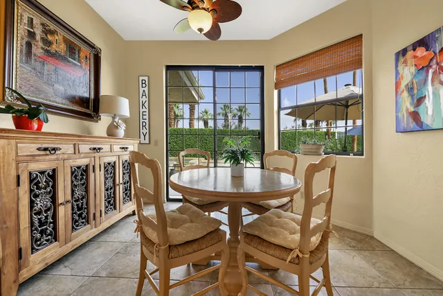 a living room with furniture a flat screen tv and a floor to ceiling window