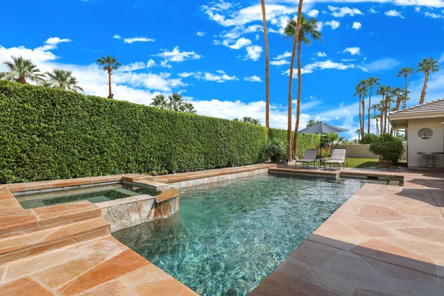 a patio with a patio table and chairs