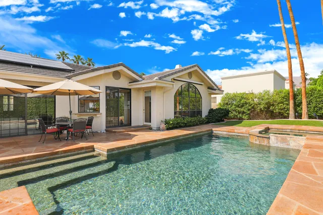 a view of backyard with plants and outdoor seating