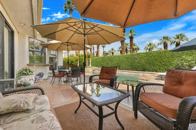 a view of a patio with chairs and table