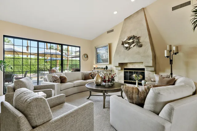 a living room with furniture and a potted plant