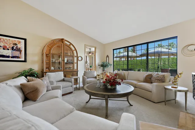 a kitchen with stainless steel appliances granite countertop a sink refrigerator and cabinets