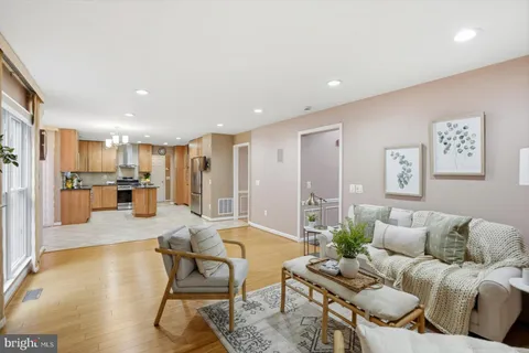 a living room with furniture and kitchen view
