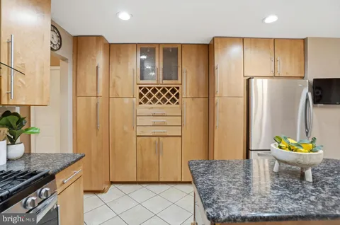 a kitchen with stainless steel appliances granite countertop a refrigerator and a stove