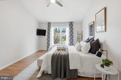a bedroom with a bed and a potted plant