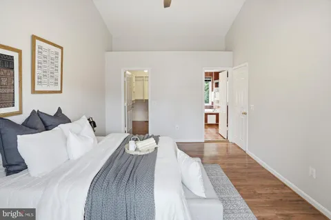 a bedroom with a bed and painting on the wall