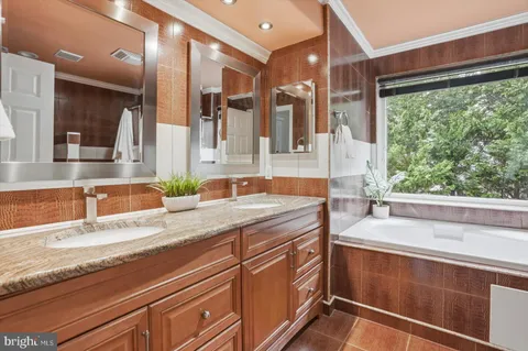 a spacious bathroom with a granite countertop sink and a large mirror