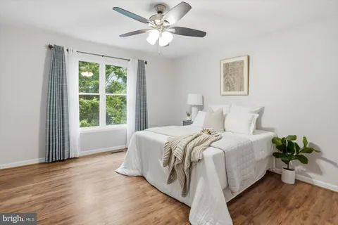 a spacious bedroom with a bed and a window
