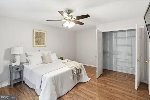 a bed room with a bed and a ceiling fan
