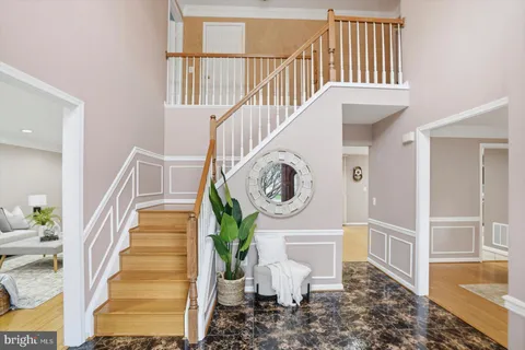 a view of a hallway with entryway wooden floor and front door