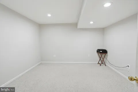 a view of a room with gym equipment and a ceiling fan