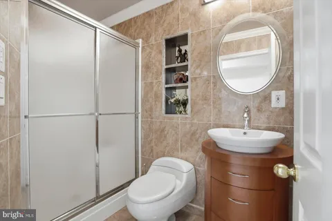 a bathroom with a toilet sink and a mirror