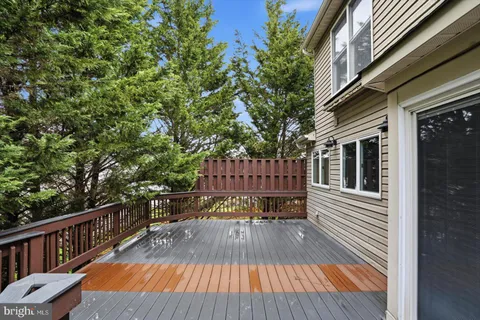 a view of balcony with wooden floor and outdoor seating