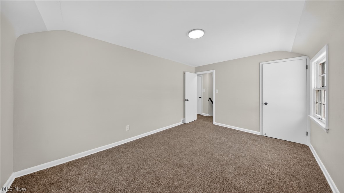 16811 Invermere Avenue Cleveland, OH 44128 - Photo 32 of 47 Unfurnished bedroom featuring vaulted ceiling and carpet flooring