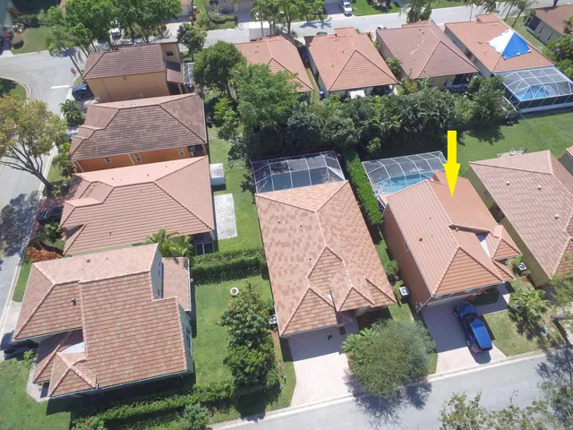 an aerial view of house with yard and swimming pool