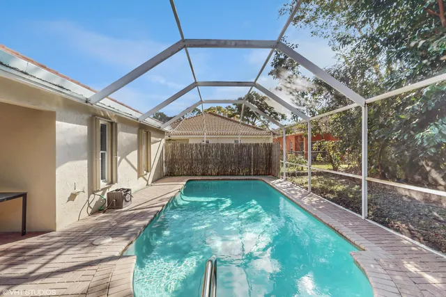 a view of a livingroom with furniture wooden floor and a gate
