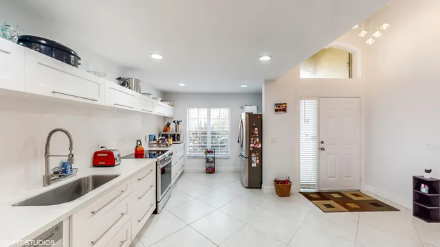 a kitchen with refrigerator and window