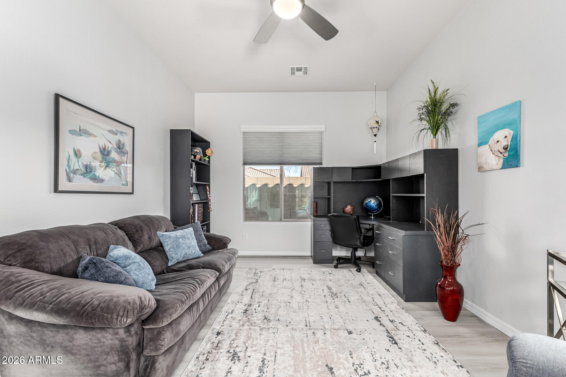 17926 West Griswold Road Waddell, AZ 85355 - Photo 10 of 73 a living room with furniture and a flat screen tv