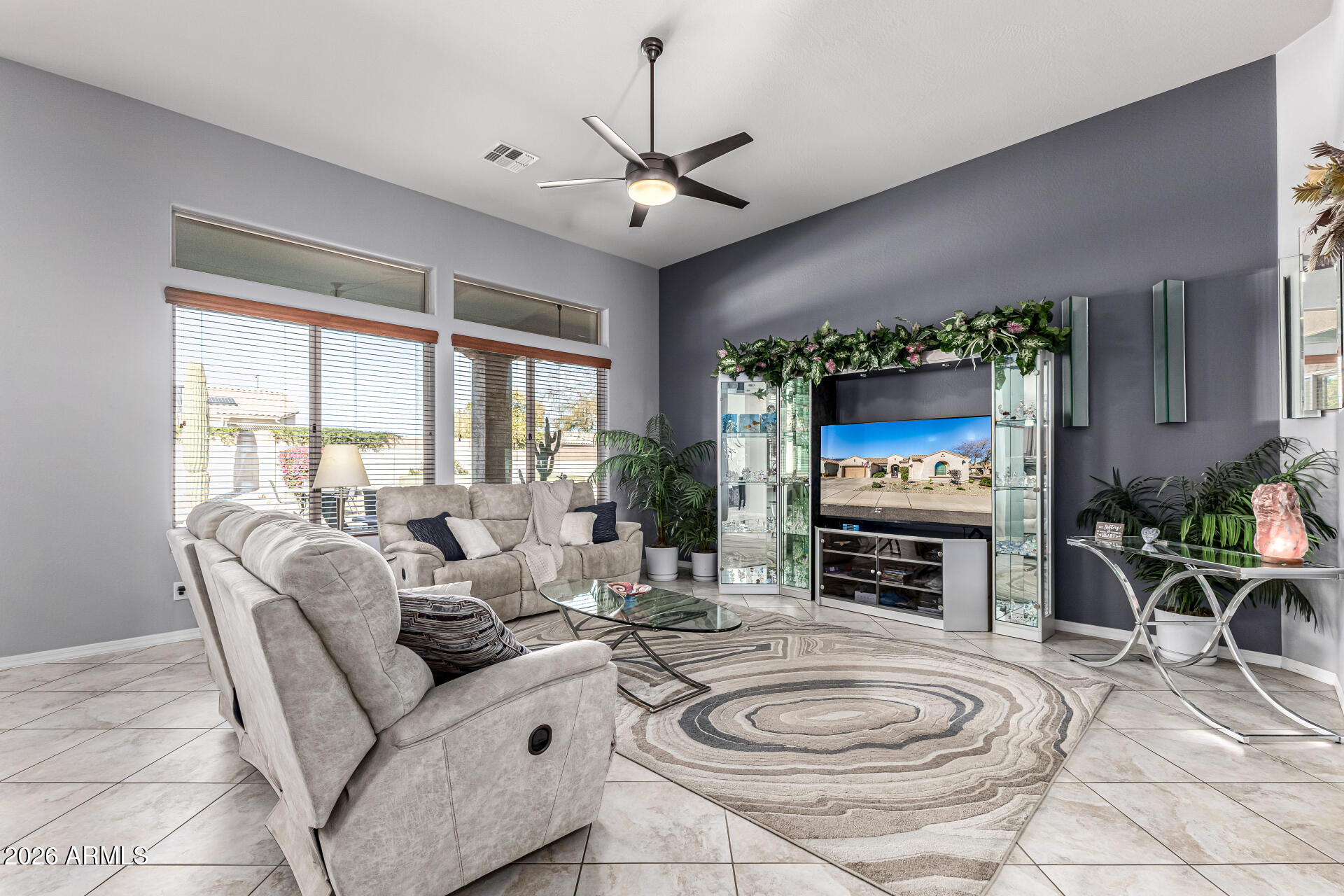 17926 West Griswold Road Waddell, AZ 85355 - Photo 16 of 73 a living room with fireplace furniture and a flat screen tv