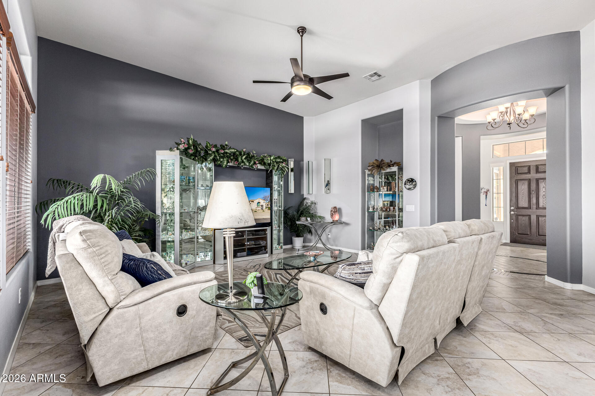 17926 West Griswold Road Waddell, AZ 85355 - Photo 18 of 73 a living room with furniture a chandelier and a window