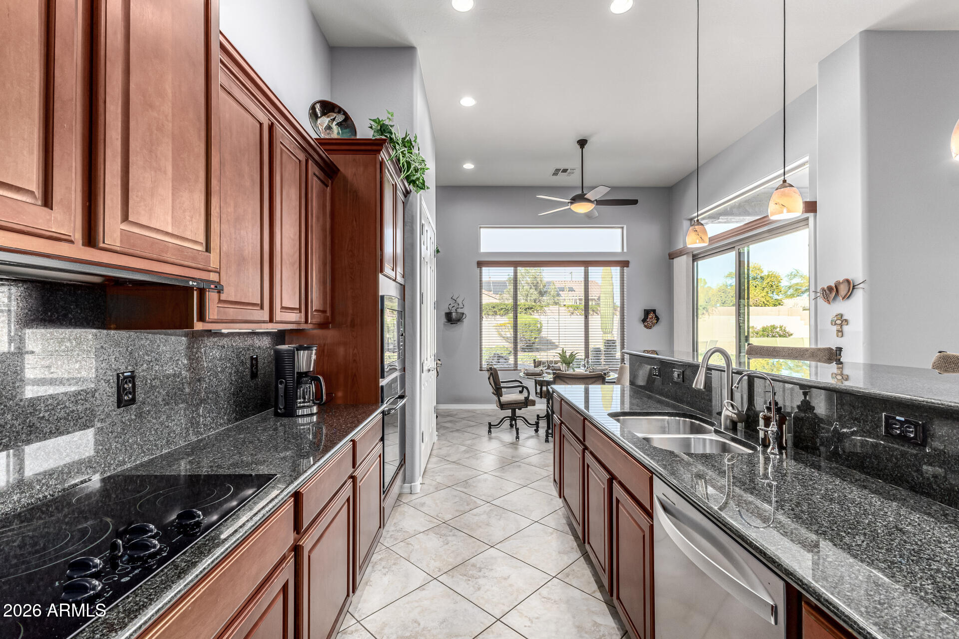 17926 West Griswold Road Waddell, AZ 85355 - Photo 20 of 73 a large kitchen with granite countertop a sink and a stove