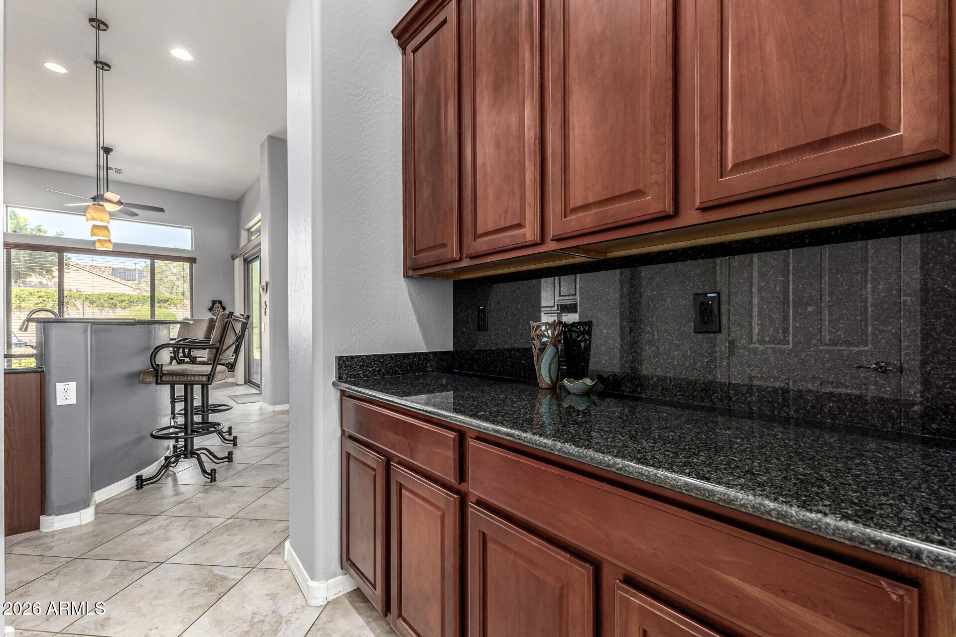 17926 West Griswold Road Waddell, AZ 85355 - Photo 21 of 73 a kitchen with granite countertop a sink a stove and cabinets